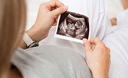 Woman looking at ultrasound image